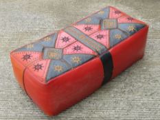 A 1960s Moroccan leather double footstool measuring 84cm wide.