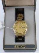 A Seiko 5 automatic wristwatch in original box, a/f (scratched to glass and date aperture surround