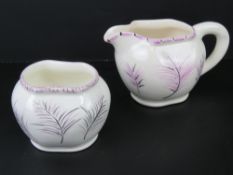 Avon Ware, England; A delightful hand painted cream and sugar bowl set, having lilac feather