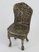 A Victorian silver miniature chair hallmarked for Birmingham 1897 weighing 26.2g, 6cm at back.
