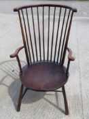 An oversized American spindle turned open arm chair in mahogany, seat 56cm wide.