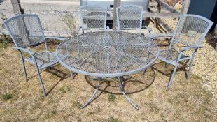 A grey lattice type metal garden table with four matching chairs.