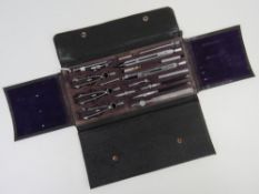 A mid century draughtsman's or cartographer's set of technical drawing compasses within fitted