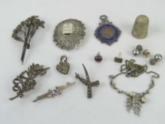 A quantity of silver and costume jewellery including marcasite brooch, Jerusalem brooch,