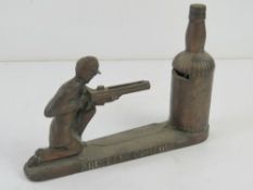 A c1950s Southern Comfort mechanical money box in the form of a Civil War soldier with gun and 100