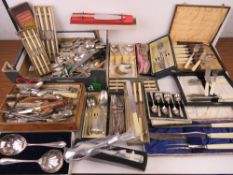 A large quantity of assorted flatware inc sets of silver plated cutlery.