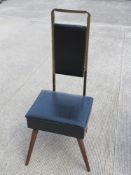 A mid century gentleman's chair, having lift up seat opening to reveal compartment within, 109cm