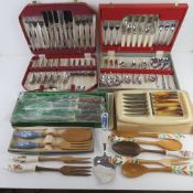 A quantity of assorted boxed cutlery sets and serving items inc horn handled carving set by Anton