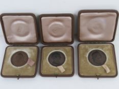 Three bronze Harrow School commemorative medallions each in presentation box.