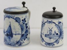 Two late 19th/early 20thC Delft lidded tankards, the larger having ceramic and pewter lid with