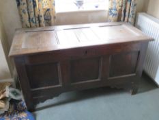 A late 17th early 18th century country made oak coffer having plain panels and original wire hinges,