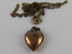An Edwardian heart pendant stamped indistinctly (9ct?) on chain stamped 9ct (chain a/f), total