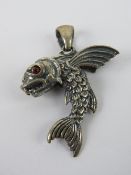 A flying fish pendant having red stone eyes, stamped 925, 4.77cm in length, 8.3g.