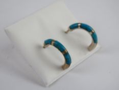 A pair of silver and turquoise half hoop earrings stamped 925 to the butterfly backs.