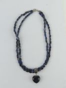 A silver and blue agate two strand beaded necklace with heart pendant upon, clasp stamped 925.