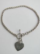 A 925 silver bracelet with heart tag upon, T-bar clasp, approx 19cm in length.