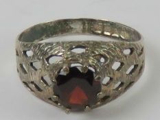 A HM silver red stone ring, pierced lattice design, hallmarked for Birmingham, size O-P.