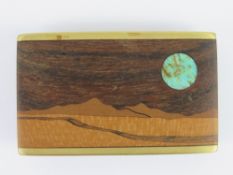 A Native American buckle inlaid with turquoise and various wood, maker's mark to back and dated 87,