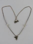 A cherub pendant on Native American style silver beaded chain with two white pearls upon,