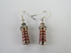 A pair of enamelled earrings in the form of lighthouses.