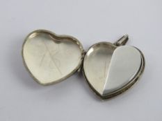 A silver heart shaped locket having unusual trinket / memory box within, stamped silver, approx 2.