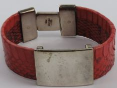 A silver and red reptile skin bangle, stamped 925, approx 6cm internal dia.