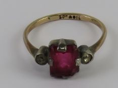 An early 20thC 9ct gold and silver ring having octagonal cut, red glass stone centre,