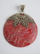 A disc pendant in red having 925 silver mount, 3.8cm wide.