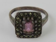 A silver marcasite and purple stone ring of Art Deco style, stamped silver, size K.