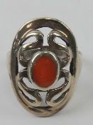 A silver and carnelian ring having pierced pattern in oval frame, stamped 925, size M-N.