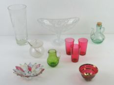 An etched glass vase together with a cut glass pedestal bowl, condiment pot,
