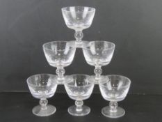 Six plain glass sundae dishes.