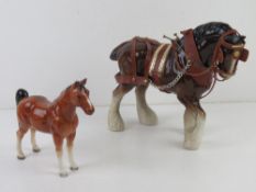 A German figurine of a horse together with another figurine of a Shire horse in bridle etc.