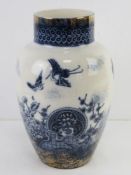 A blue and white Oriental style vase having cranes and floral pattern upon, 28cm high.