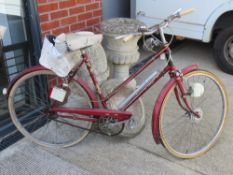 A vintage Raleigh bicycle with accessories.