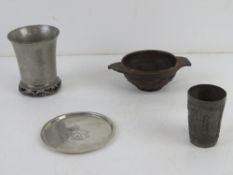 A carved wooden quaich together with a German pewter tot cup,