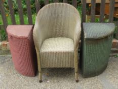 A pair of Lloyd Loom W Lusty & Sons Ltd laundry baskets in green and red respectively.
