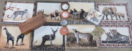 A quantity of safari themed place mats, animal wine glass jewellery and a wooden box.
