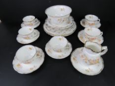 A part tea service having floral pattern on white ground with gilded rim inc bowl, tea cups,