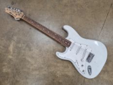 An AXL Player Delux electric guitar.