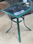 A metal and glass bistro table.