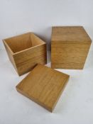 Two contemporary oak effect storage boxes each 25 x 25 x 25cm.