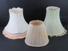Three assorted silk lamp shades.