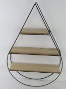 A contemporary three-shelf wall unit in the form of a teardrop, black metal, 65 x 42cm.