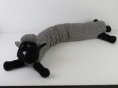 A draught excluder in the form of a black-faced sheep.
