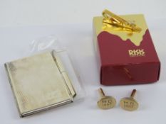 A RISIS orchid tie clip in original packaging,