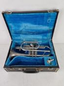 A Melody Maker trumpet in fitted case having silvered mouthpiece.