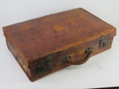 A vintage pigskin leather suitcase having continental voyage labels, 55cm wide.