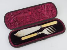 A boxed presentation fish serving set comprising plated knife and fork with ivorine handles.