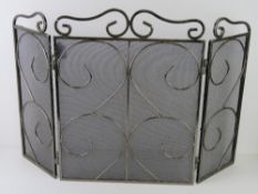 A chrome three-fold fire screen standing 53.5cm high.